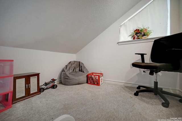 carpeted office space featuring baseboards and lofted ceiling
