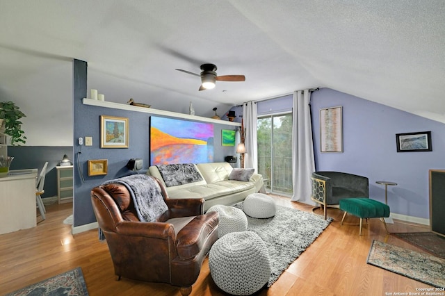 living room featuring a ceiling fan, baseboards, wood finished floors, and lofted ceiling