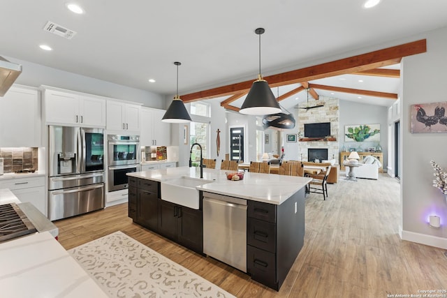 821 Bingham Ln, New Braunfels, TX 78132 - kitchen featuring white cabinets, light countertops, appliances with stainless steel finishes, and a sink