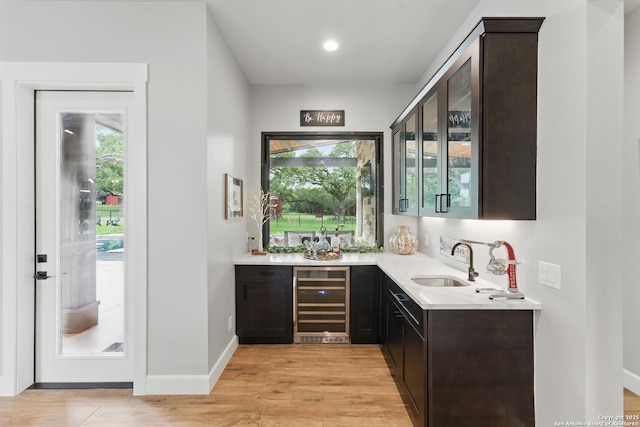821 Bingham Ln, New Braunfels, TX 78132 - bar with wine cooler, baseboards, a sink, indoor wet bar, and light wood-style floors