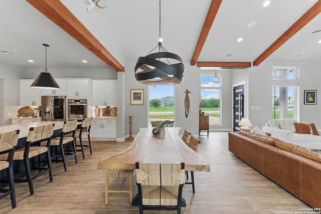 821 Bingham Ln, New Braunfels, TX 78132 - dining space with light wood-style flooring, recessed lighting, visible vents, and beam ceiling