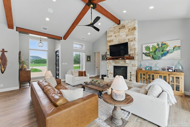 821 Bingham Ln, New Braunfels, TX 78132 - living room with baseboards, ceiling fan, wood finished floors, a fireplace, and beam ceiling