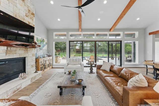 821 Bingham Ln, New Braunfels, TX 78132 - living area with wood finished floors, recessed lighting, ceiling fan, beamed ceiling, and a stone fireplace