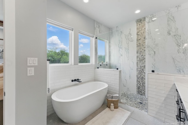 821 Bingham Ln, New Braunfels, TX 78132 - full bath featuring tile walls, recessed lighting, a walk in shower, tile patterned flooring, and a soaking tub