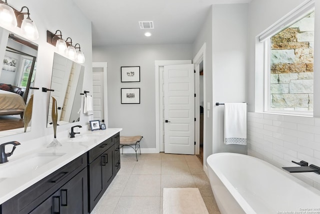 821 Bingham Ln, New Braunfels, TX 78132 - full bath featuring a sink, a soaking tub, double vanity, and visible vents