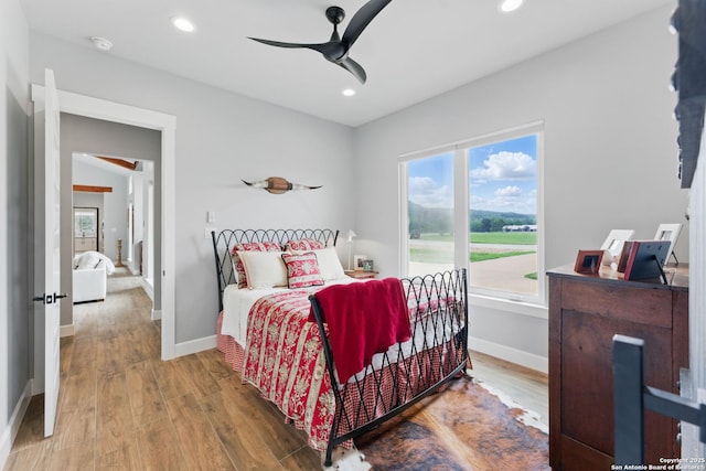 821 Bingham Ln, New Braunfels, TX 78132 - bedroom featuring baseboards, recessed lighting, and wood finished floors