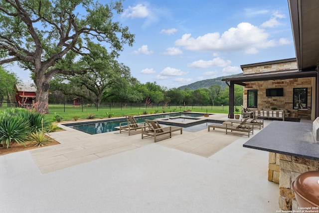 821 Bingham Ln, New Braunfels, TX 78132 - view of swimming pool featuring a hot tub, fence, a mountain view, a patio, and a fenced in pool