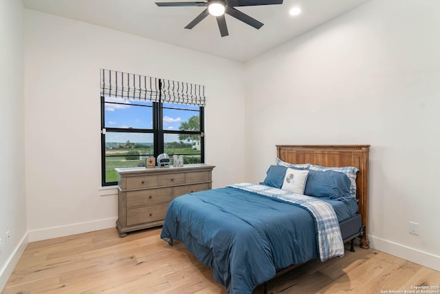 bedroom with baseboards, light wood-type flooring, a ceiling fan, and recessed lighting