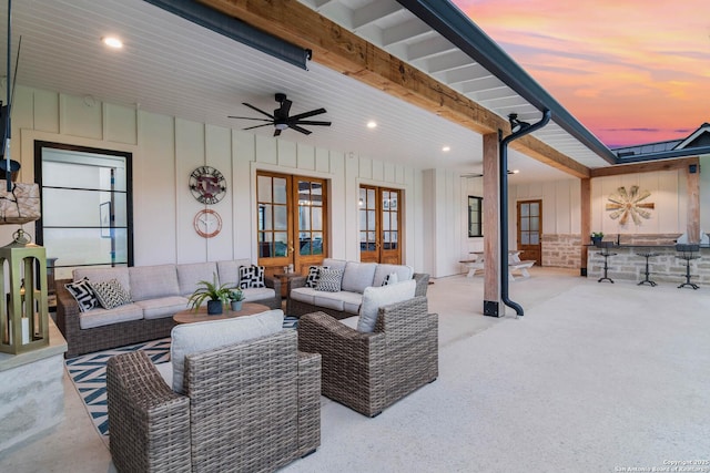 view of patio / terrace with an outdoor living space, a ceiling fan, and french doors