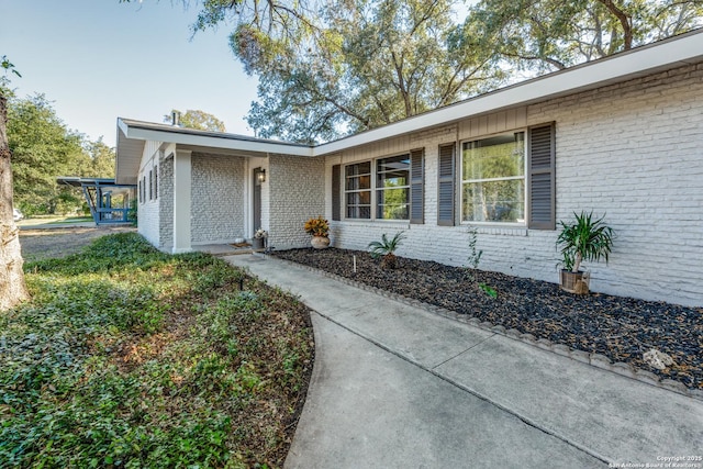 exterior space featuring brick siding