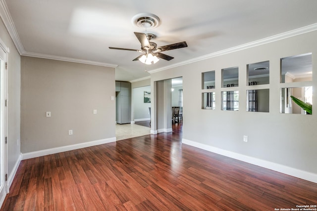 unfurnished room featuring baseboards, wood finished floors, a ceiling fan, and ornamental molding