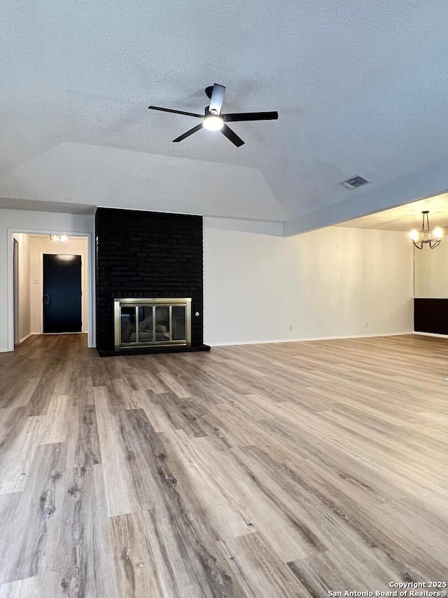 10106 Grand Park, San Antonio, TX 78239 - unfurnished living room with lofted ceiling, a ceiling fan, a textured ceiling, visible vents, and wood finished floors