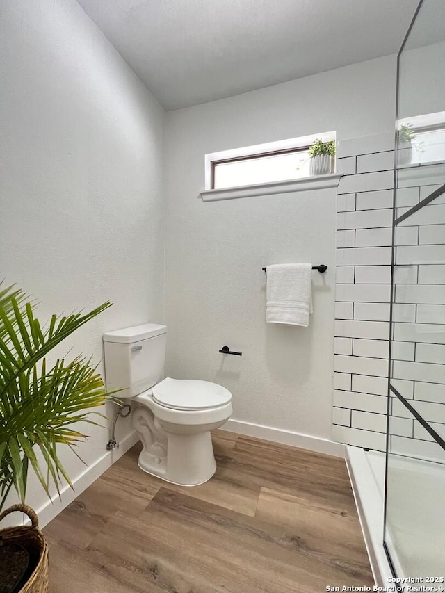 10106 Grand Park, San Antonio, TX 78239 - bathroom with toilet, a shower, baseboards, and wood finished floors