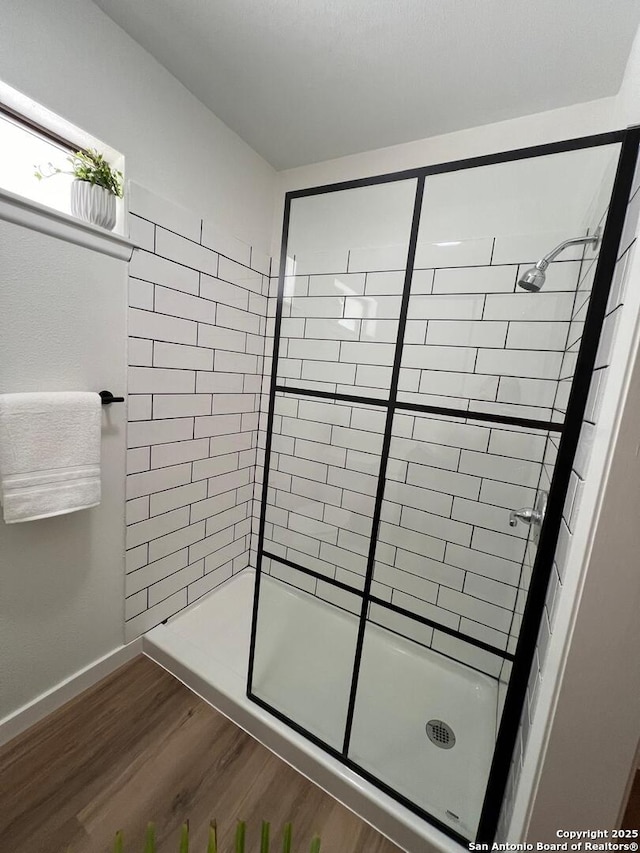 10106 Grand Park, San Antonio, TX 78239 - full bath with baseboards, a shower stall, and wood finished floors