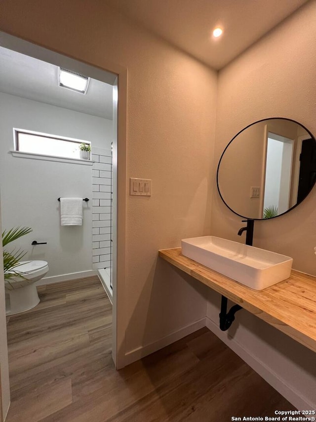 10106 Grand Park, San Antonio, TX 78239 - full bathroom with toilet, walk in shower, a sink, and wood finished floors