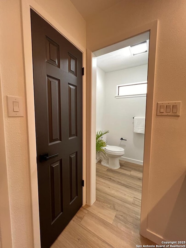 10106 Grand Park, San Antonio, TX 78239 - bathroom with toilet, baseboards, visible vents, and wood finished floors