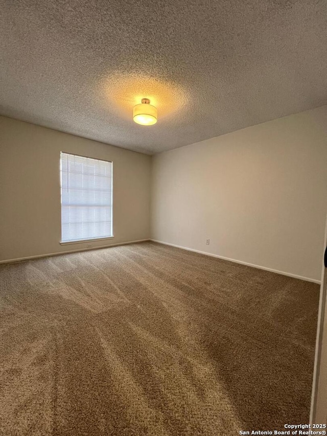 10106 Grand Park, San Antonio, TX 78239 - carpeted spare room featuring baseboards and a textured ceiling