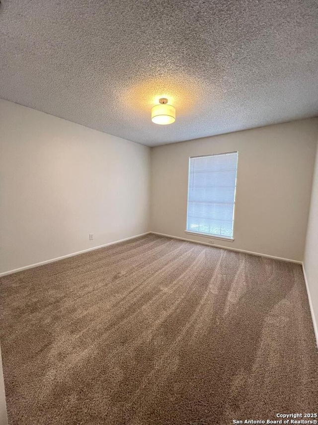 10106 Grand Park, San Antonio, TX 78239 - unfurnished room featuring a textured ceiling, carpet floors, and baseboards