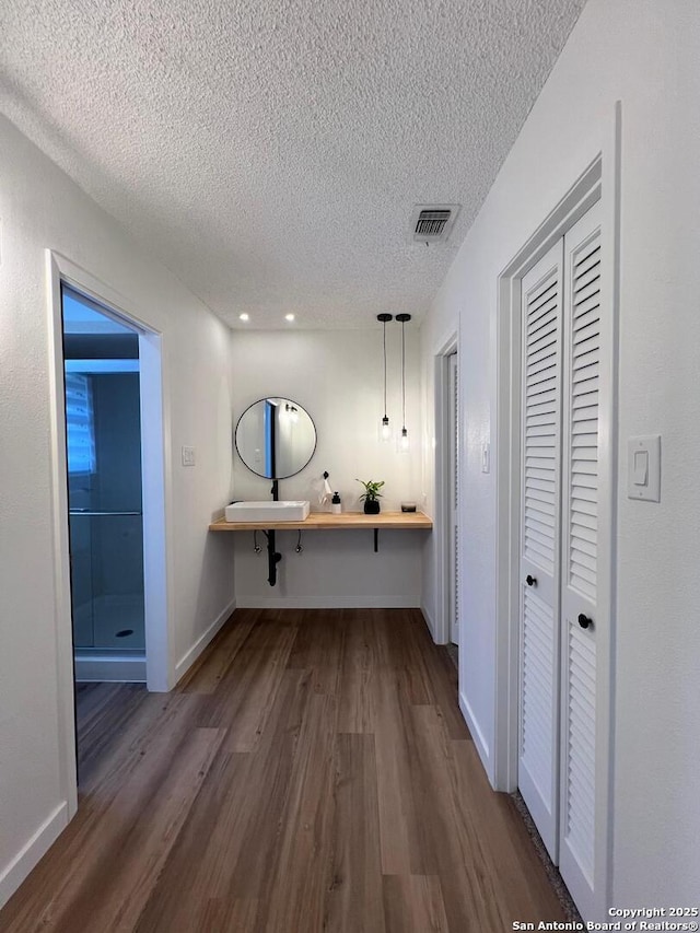 10106 Grand Park, San Antonio, TX 78239 - interior space featuring baseboards, dark wood finished floors, visible vents, and a textured ceiling
