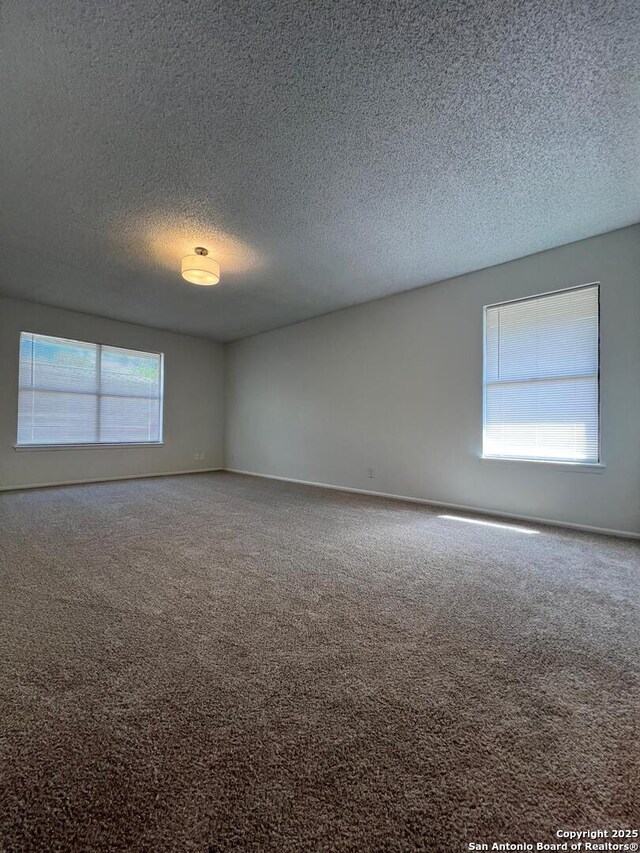 10106 Grand Park, San Antonio, TX 78239 - carpeted spare room featuring a textured ceiling and baseboards