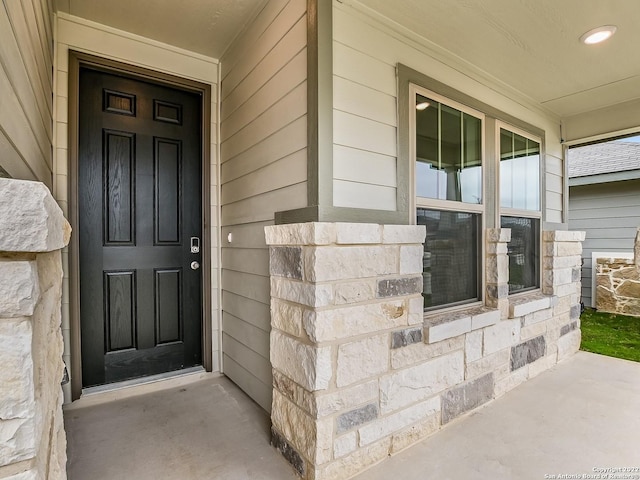 4532 Appaloosa Crst, San Antonio, TX 78245 - doorway to property featuring stone siding and a porch