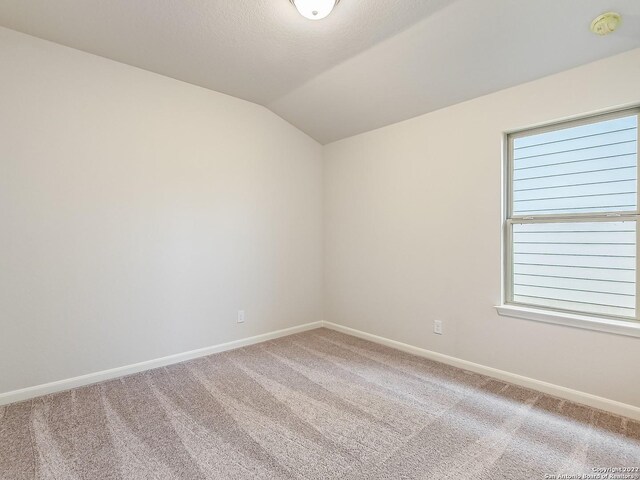 4532 Appaloosa Crst, San Antonio, TX 78245 - unfurnished room with baseboards, lofted ceiling, and carpet floors