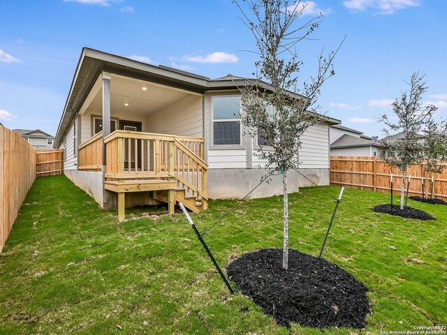 4532 Appaloosa Crst, San Antonio, TX 78245 - rear view of property with a fenced backyard, a deck, and a yard