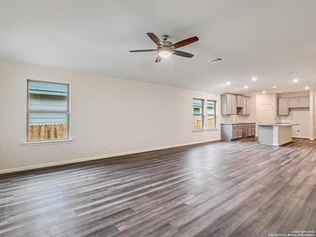 4532 Appaloosa Crst, San Antonio, TX 78245 - unfurnished living room featuring a sink, dark wood-type flooring, visible vents, recessed lighting, and a ceiling fan