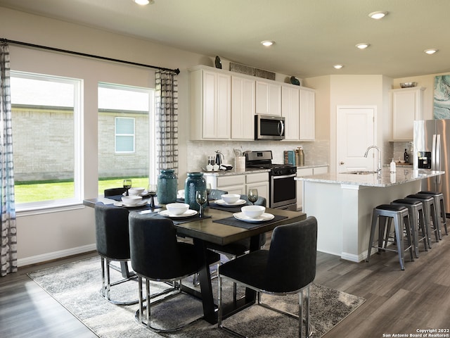 4539 Appaloosa Crst, San Antonio, TX 78245 - dining space with baseboards, recessed lighting, and wood finished floors