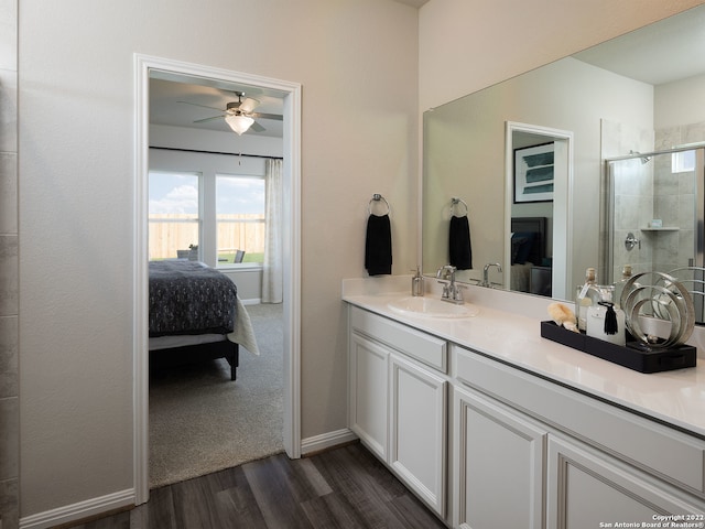 4539 Appaloosa Crst, San Antonio, TX 78245 - full bath featuring a stall shower, ensuite bath, ceiling fan, vanity, and wood finished floors