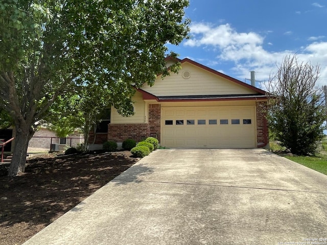 458 Vicksburg, Kerrville, TX 78028 - view of front of house with driveway, brick siding, and a garage
