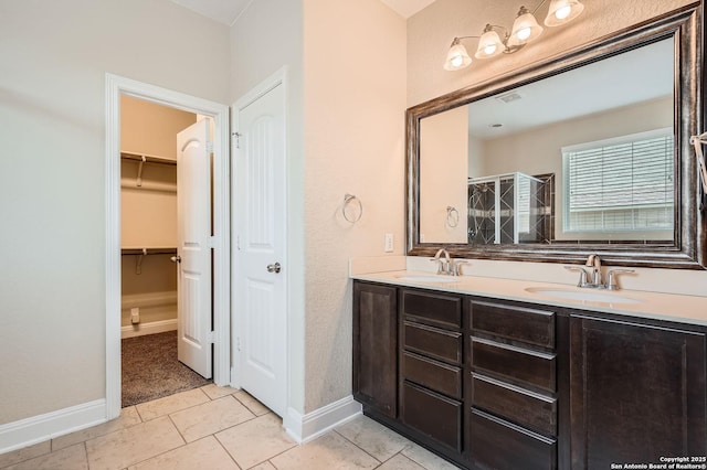 2253 Sun Stone, New Braunfels, TX 78130 - full bathroom with a sink, double vanity, a stall shower, and tile patterned flooring