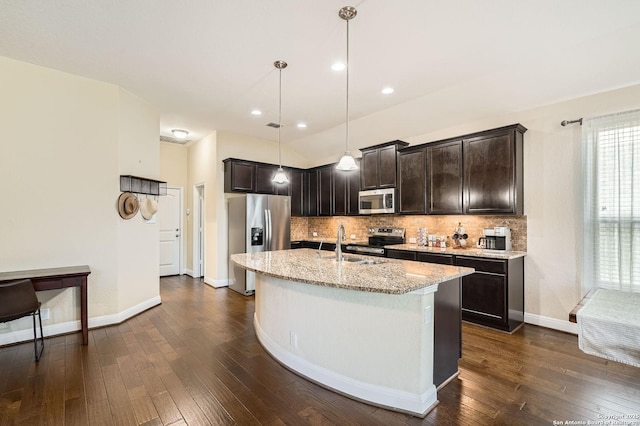 2253 Sun Stone, New Braunfels, TX 78130 - kitchen with light stone counters, appliances with stainless steel finishes, decorative backsplash, and dark wood-type flooring
