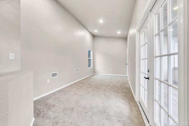 carpeted empty room featuring a wealth of natural light, baseboards, visible vents, and recessed lighting