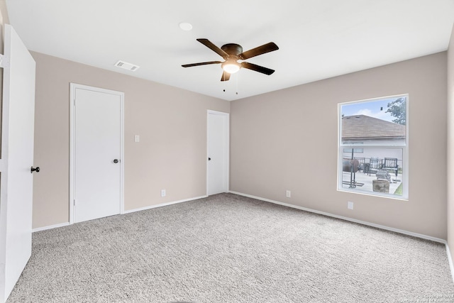 interior space featuring ceiling fan, carpet flooring, baseboards, and visible vents