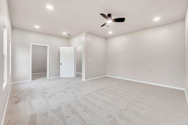 spare room featuring a ceiling fan, light carpet, and recessed lighting