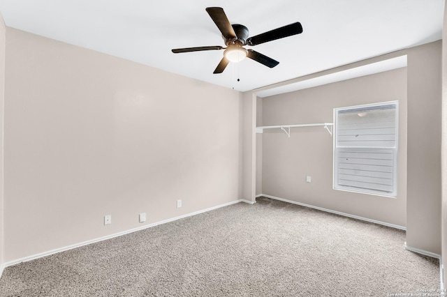 carpeted empty room with baseboards and ceiling fan