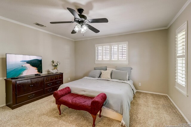 carpeted bedroom featuring ornamental molding, a ceiling fan, and baseboards