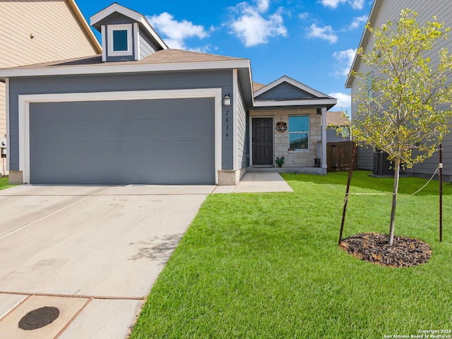 2834 Millikan Dr, Converse, TX 78109 - view of front of property featuring an attached garage, driveway, a front lawn, and stone siding