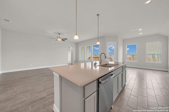 5303 Pinder Way, Schertz, TX 78108 - kitchen with stainless steel dishwasher, a healthy amount of sunlight, visible vents, a sink, and open floor plan