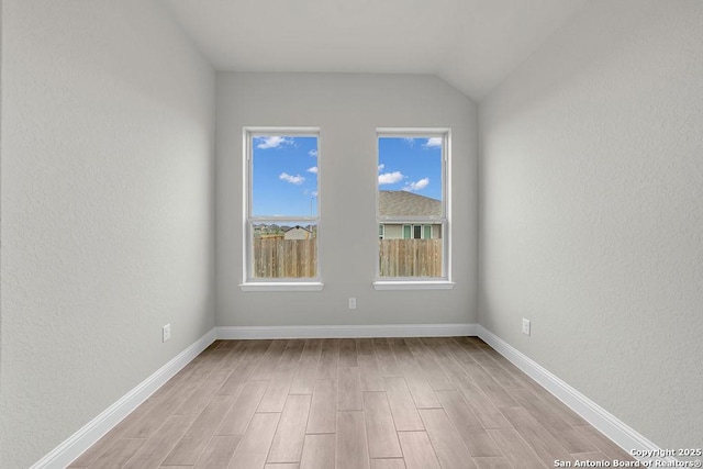 5303 Pinder Way, Schertz, TX 78108 - spare room with baseboards, lofted ceiling, light wood finished floors, and a textured wall