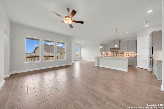 5303 Pinder Way, Schertz, TX 78108 - unfurnished living room with a ceiling fan, light wood-style flooring, recessed lighting, baseboards, and visible vents