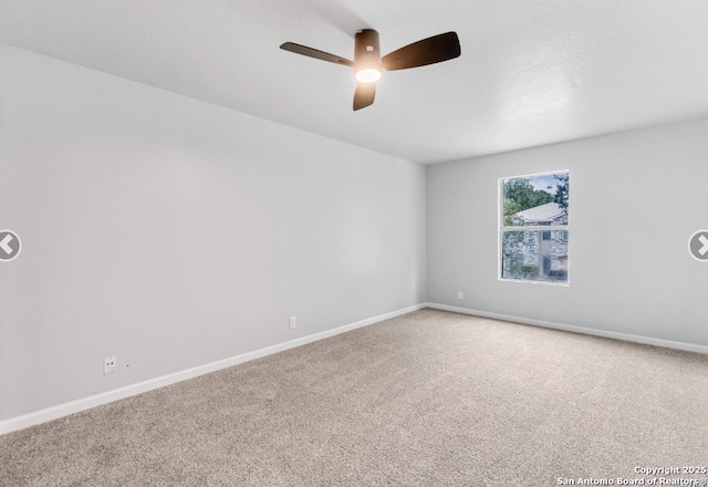 empty room featuring a ceiling fan, baseboards, and carpet