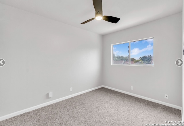 spare room with a ceiling fan, baseboards, and carpet floors