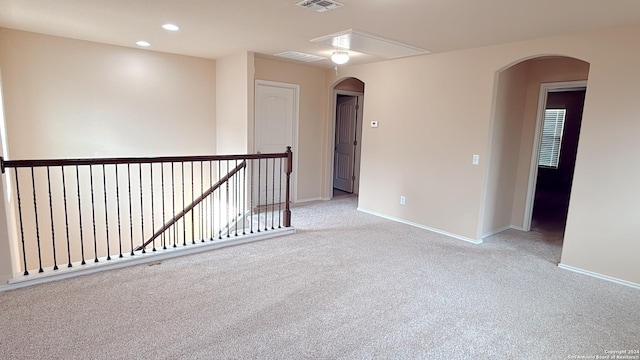 8411 Puente, San Antonio, TX 78223 - unfurnished room featuring light colored carpet, arched walkways, and baseboards