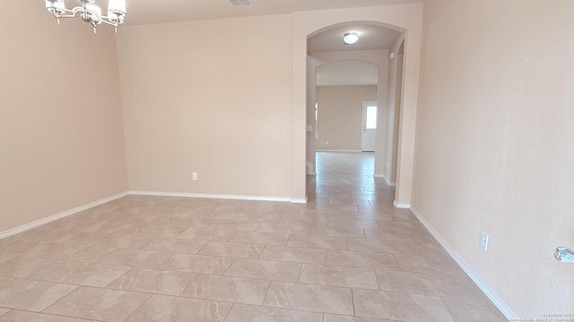 8411 Puente, San Antonio, TX 78223 - spare room with visible vents, baseboards, arched walkways, a chandelier, and light tile patterned flooring