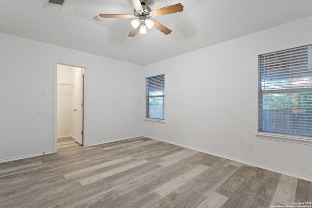 empty room featuring a healthy amount of sunlight, light wood-type flooring, and visible vents