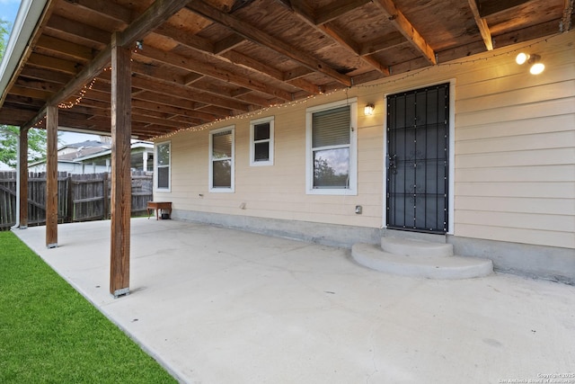 view of patio / terrace featuring entry steps and fence