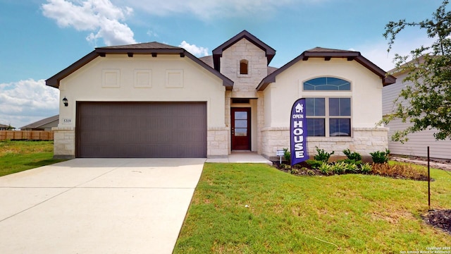 view of front facade featuring stone siding, an attached garage, and a front yard
