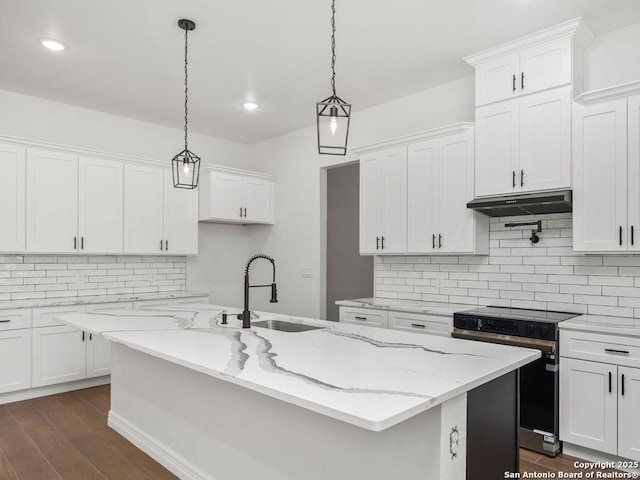 kitchen featuring a sink, white cabinets, a center island with sink, stainless steel range with electric cooktop, and under cabinet range hood